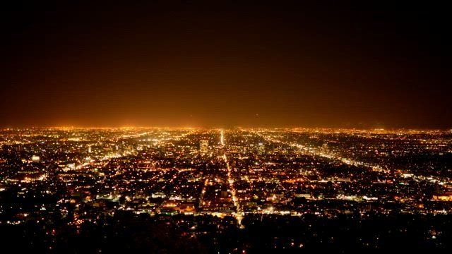 Vue aérienne d’une ville illuminée la nuit illustrant la distribution électrique urbaine.